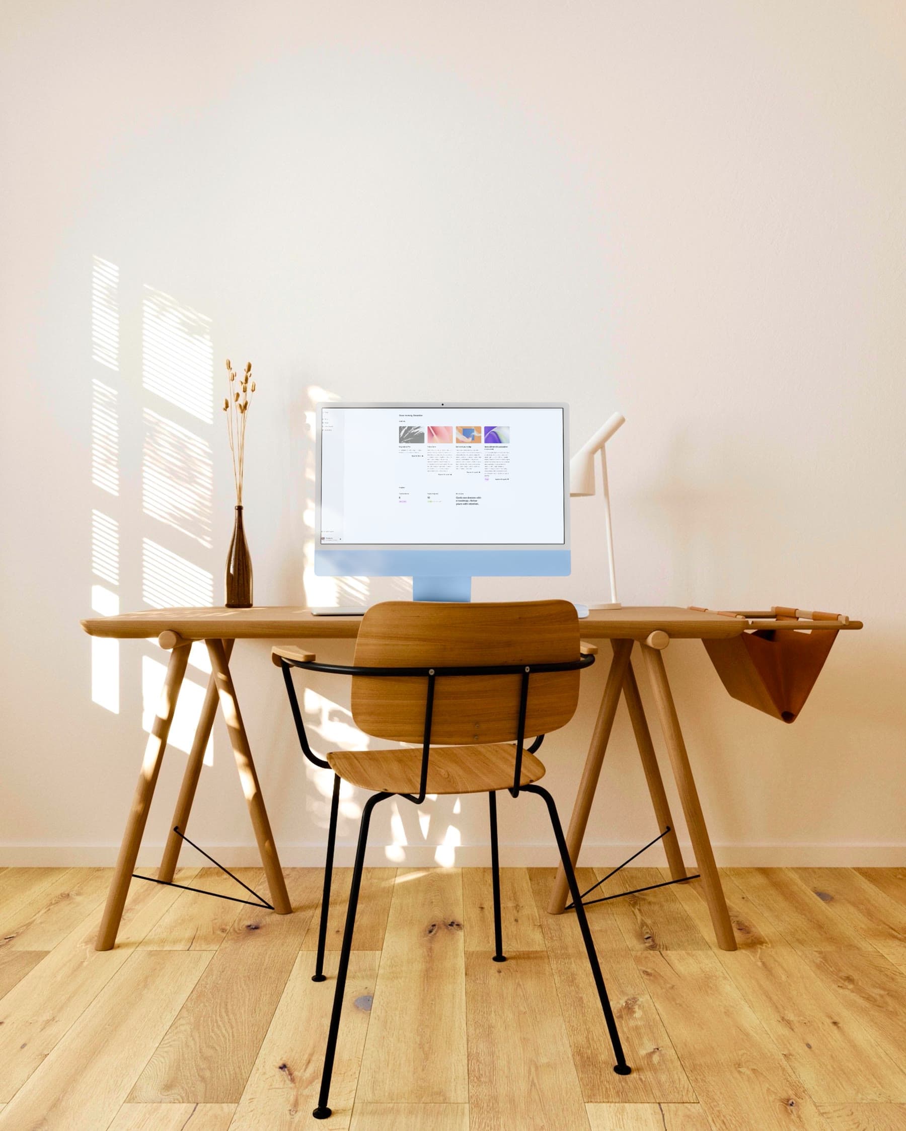 Fred on an iMac in a bright workspace.